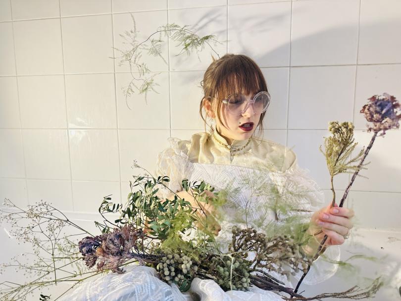 punk looking model wears bride costume with wild flowers