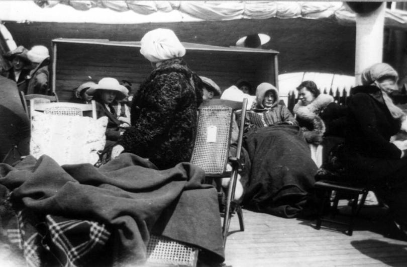 Survivors sitting on deck on the Carpathia after being rescued
