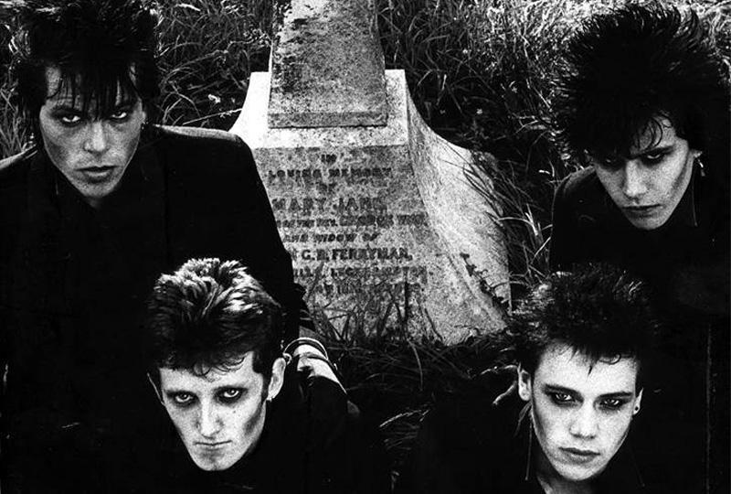 Screaming Dead members in gothic hair and make up sitting around a gravestone