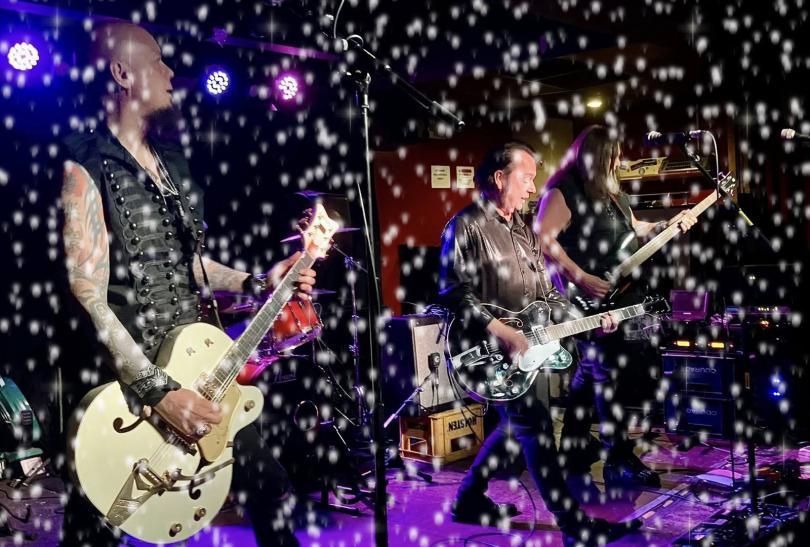 The Go Go Cult on stage, with a snow filter over the top