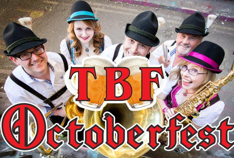 Image of a band dressed in Bavarian costumes and holding instruments with the TBF Octoberfest logo over the top