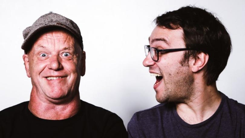 Two middle-aged men - one in a cap, gurning at the camera, the other in glasses with a shocked grin