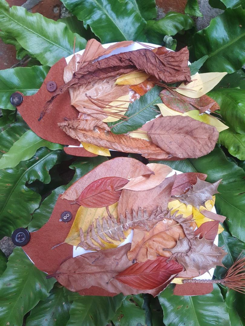 Colourful image of a crafted hedgehog made from autumn leaves