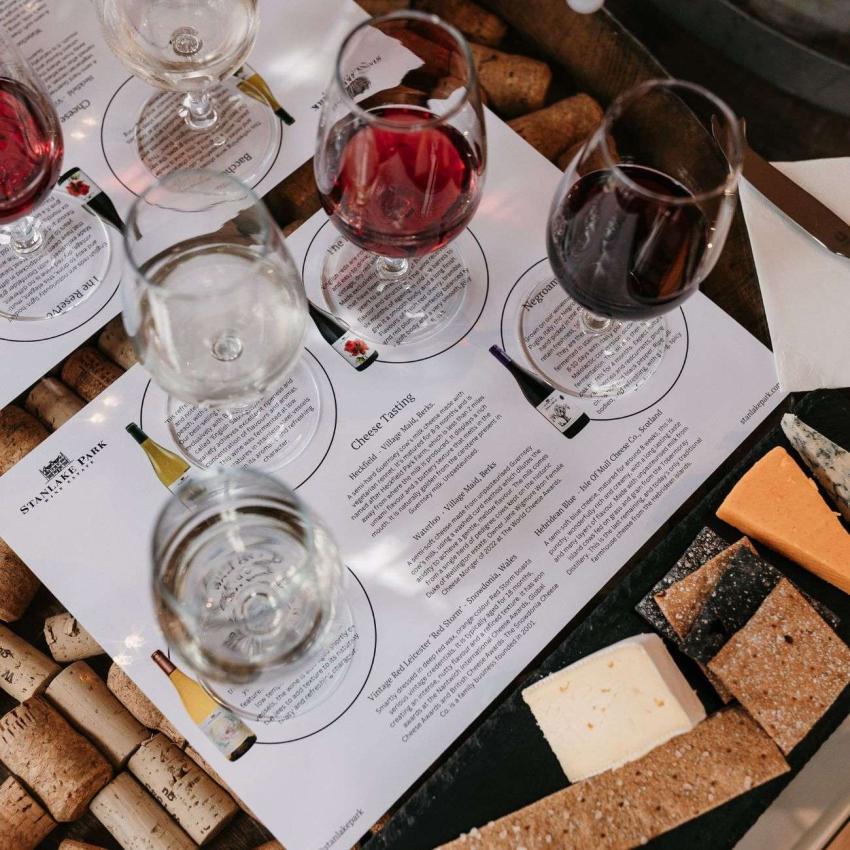 A close up of wine glasses and a cheese board