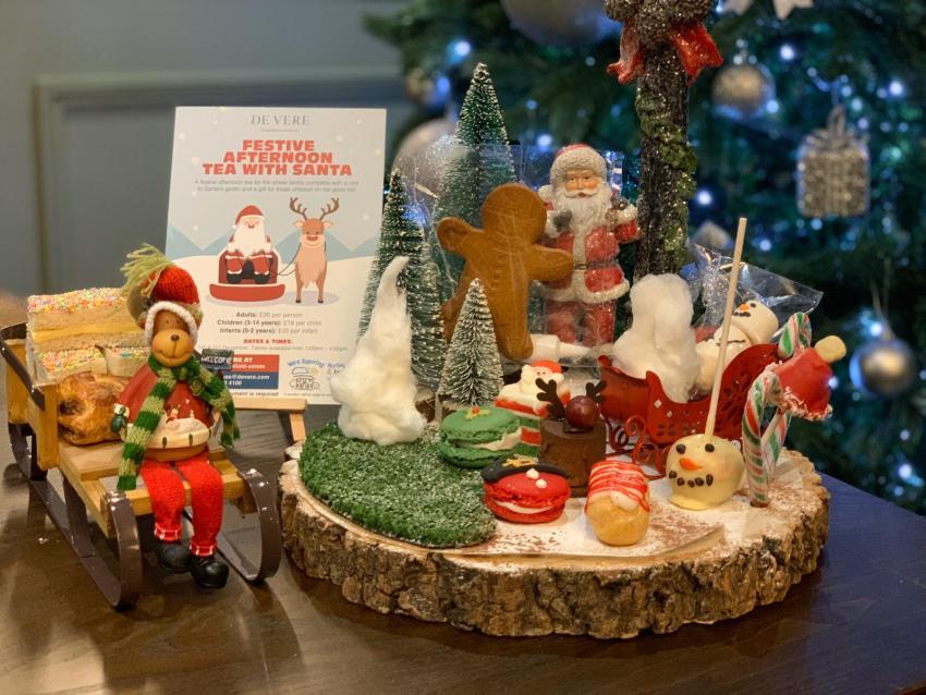 The image shows the children's festive afternoon tea served on a sleigh and log slice.