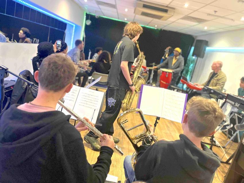 Horn section perform their music piece 