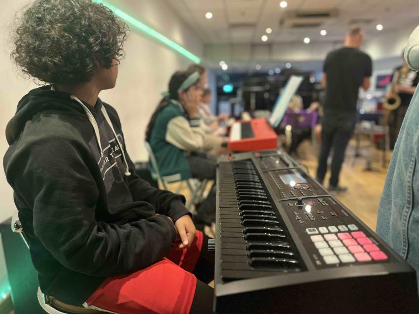Young boy and girl learning to play keyboard