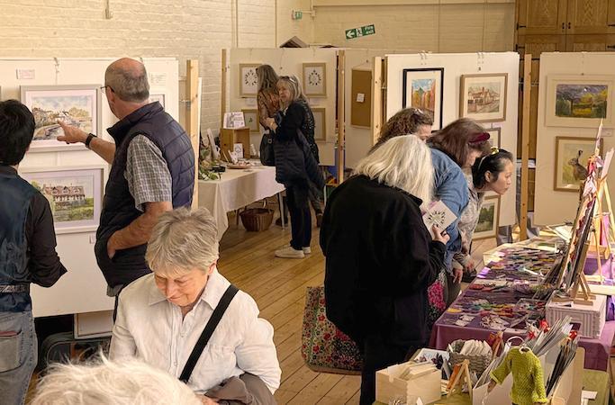 People viewing arts and craft displays