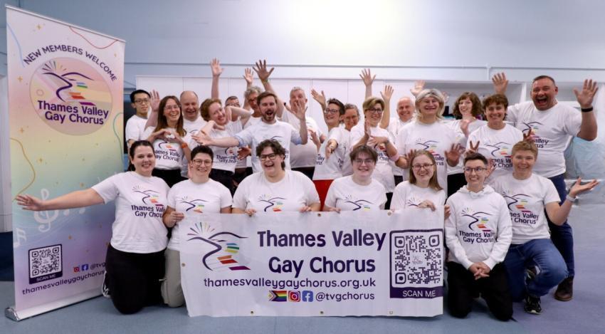 The chorus stands with its banner