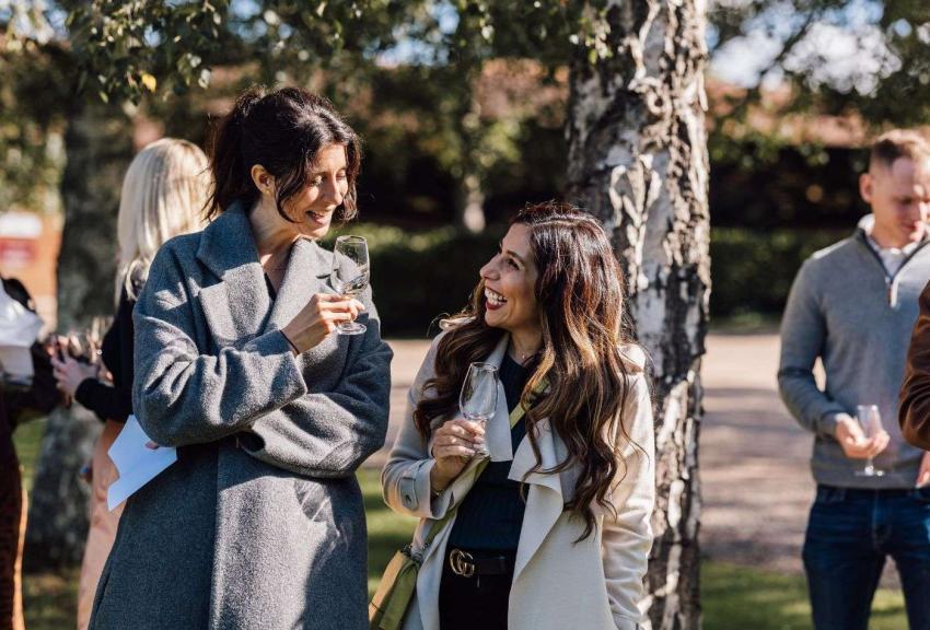 Laughing women outdoors during a tour. 