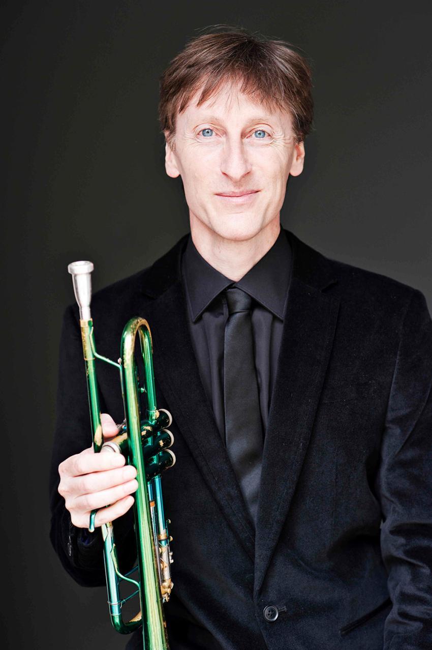 Paul Higgs holding a green trumpet