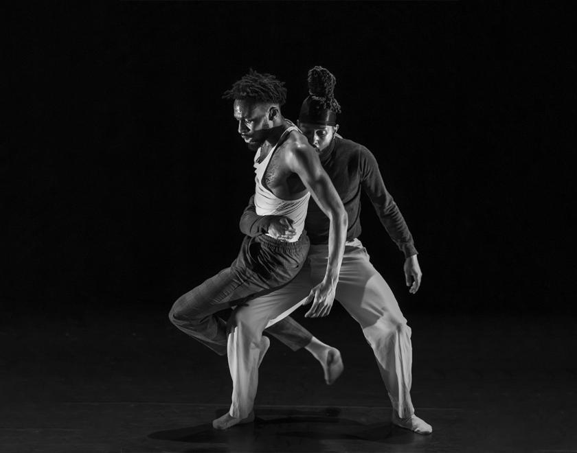 Black and white photo of two dance performers 