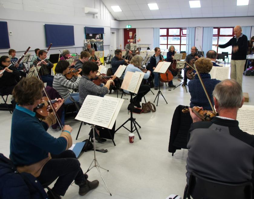 Saturday Morning Orchestra rehearsing in a white room