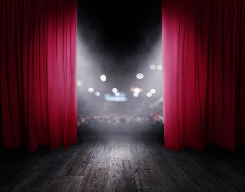 stage with curtains opening, looking out onto the audience