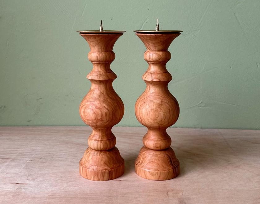 Two identical pillar Candlesticks made from cherry wood with brass candle mounts