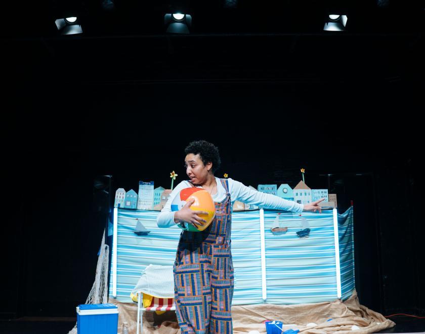 Photo of the lead performer holding a beach ball.