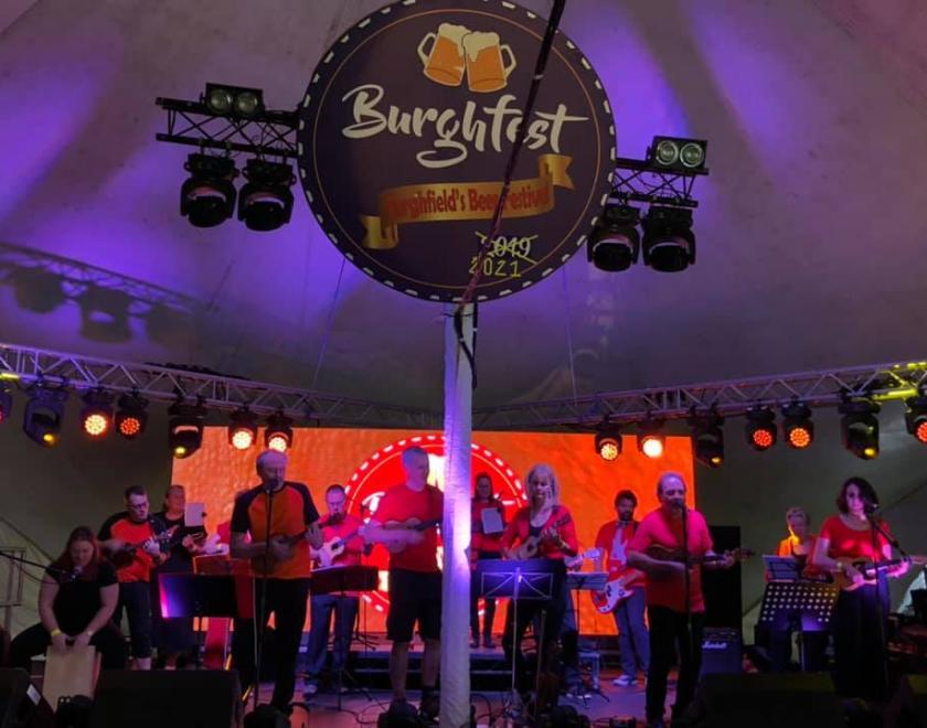 Small Strings Ukulele band performing in 2021, back on the Bar Stage in 2026
