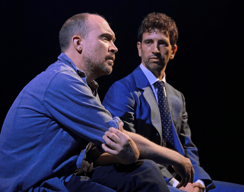 Production photo: Close-up photo of two men having a conversation