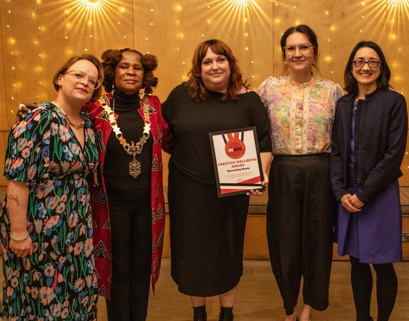 The team from Becoming Mums pose with the Creative Wellbeing Award certificate alongside presenter Donna Pentelow and the Mayor of Reading