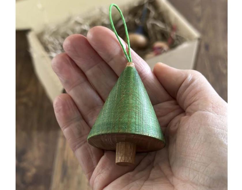 A Christmas tree shaped wooden ornament.