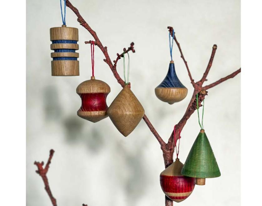 A set of six brightly coloured, hanging wooden tree decorations.