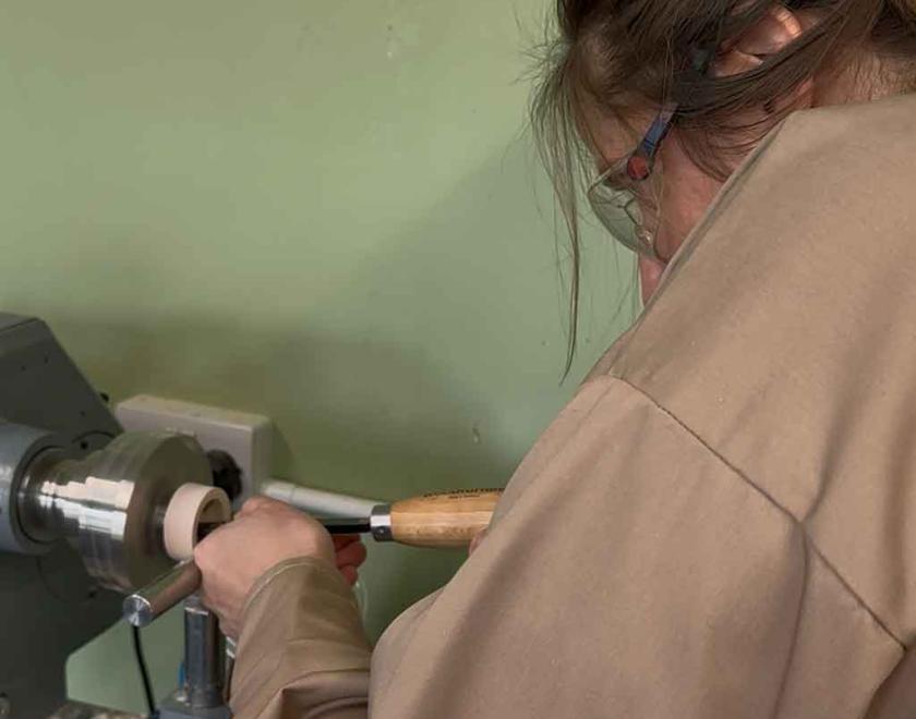 Woman hollowing her ring box on the lathe.