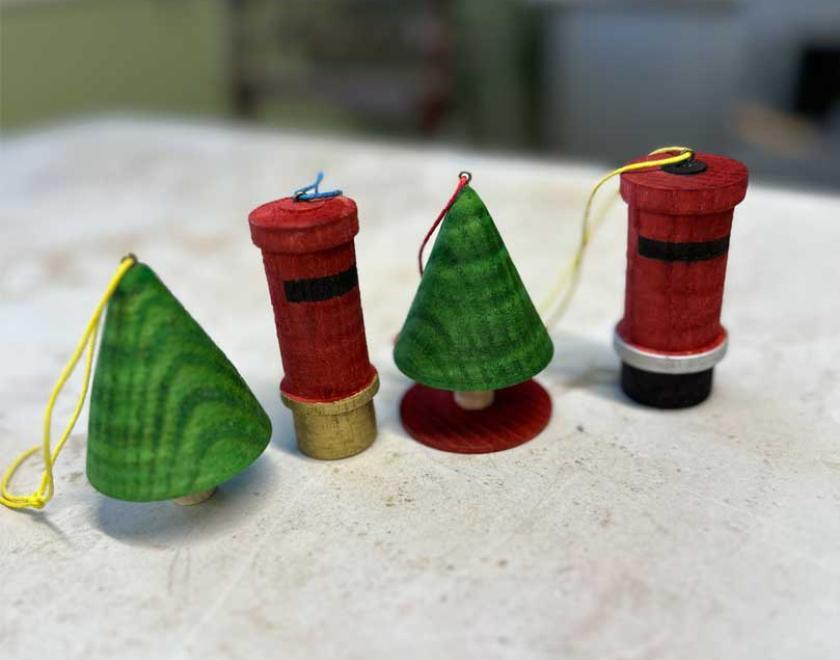 Painted wooden handmade Christmas trees and post boxes.