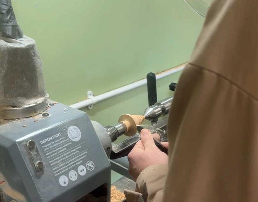 Turning a wooden Christmas tree on the lathe.