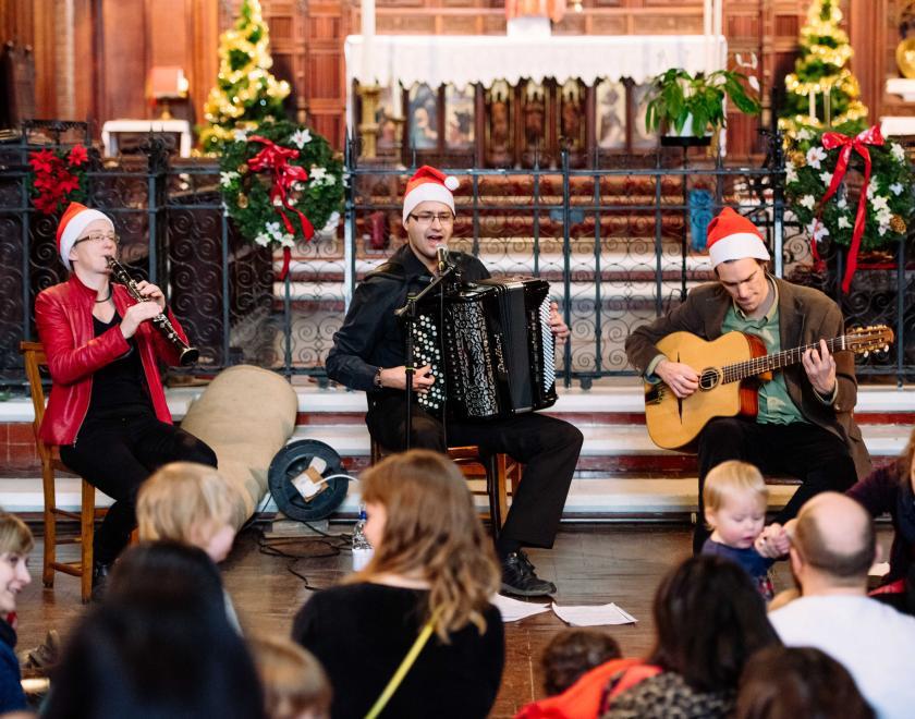 Trio of musicians performing at a festive concert