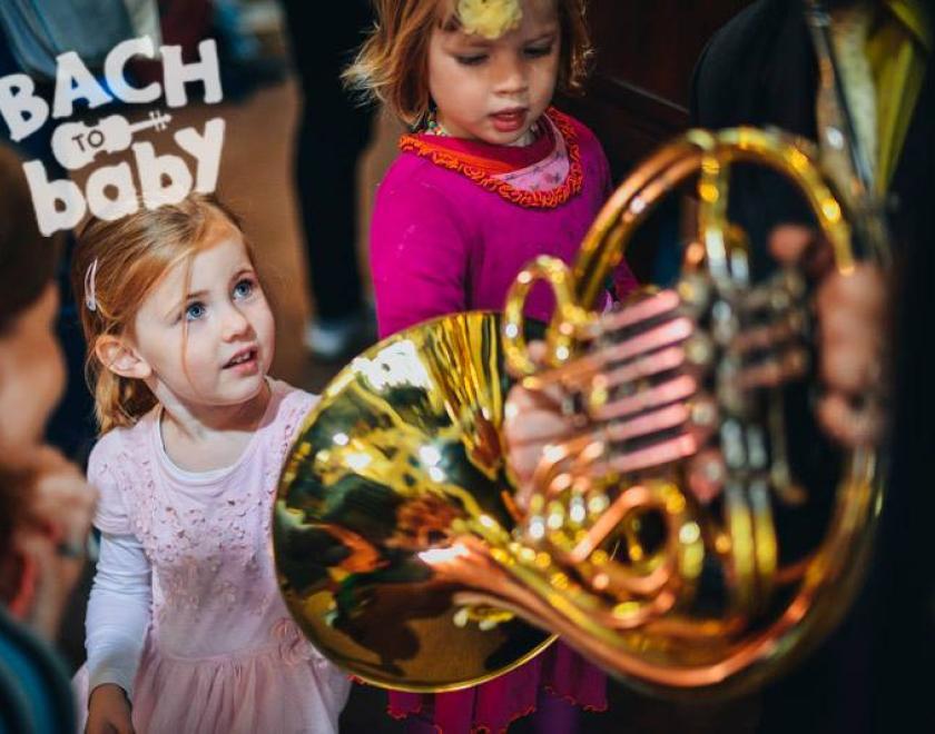 Child looking at a French Horn during a Bach to Baby concert