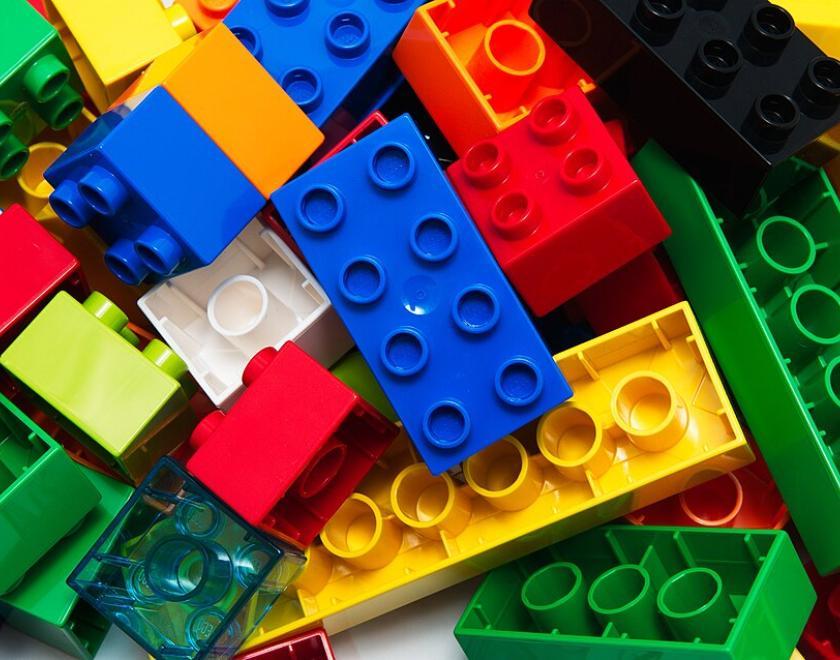 Image of assorted LEGO bricks - red, yellow, green, blue, white and brown. 