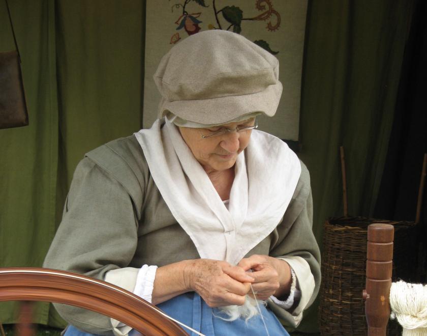 17th century re-enactment - a woman weaving.