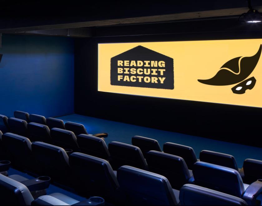 A picture the Stand and Deliver logo on a cinema screen 