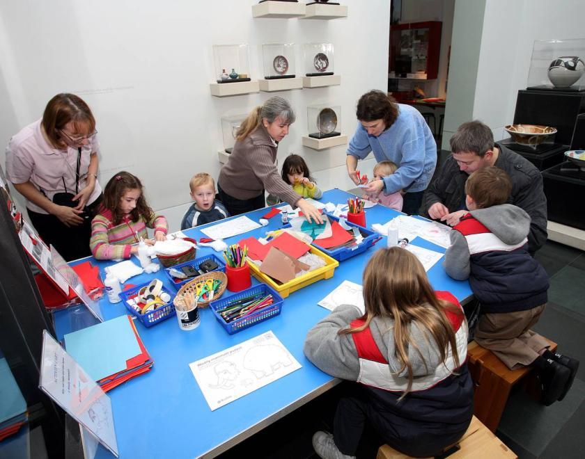 Children colouring at activity cart