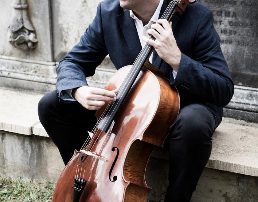 Adrian Brendel sitting with his cello