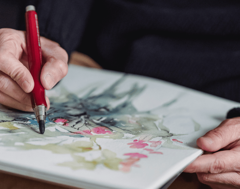 Person drawing with a pencil