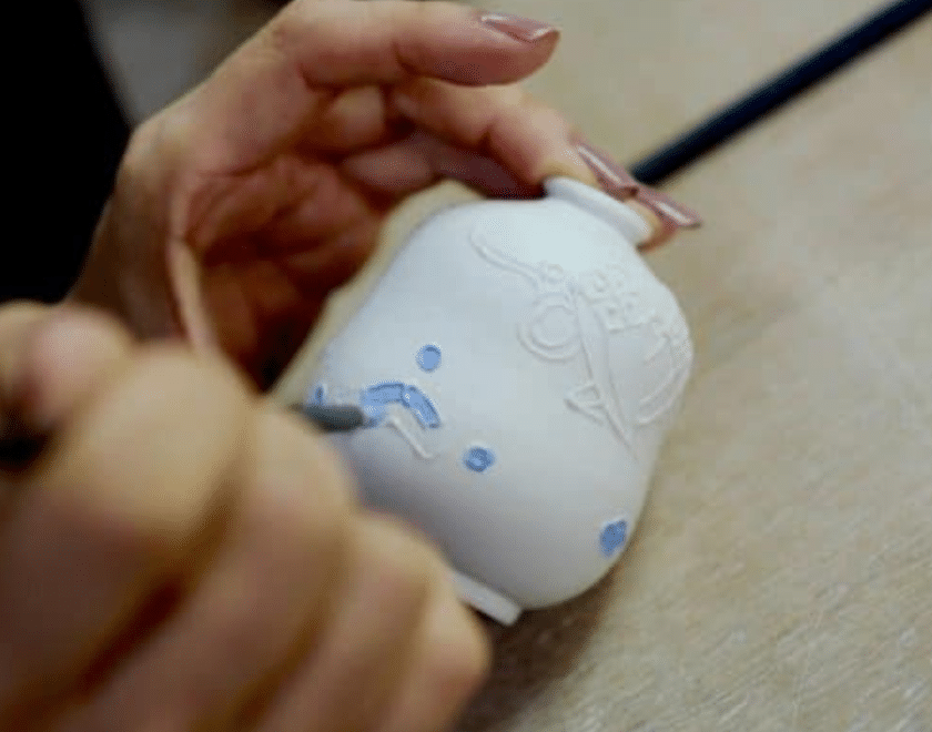 Hand painting a pot