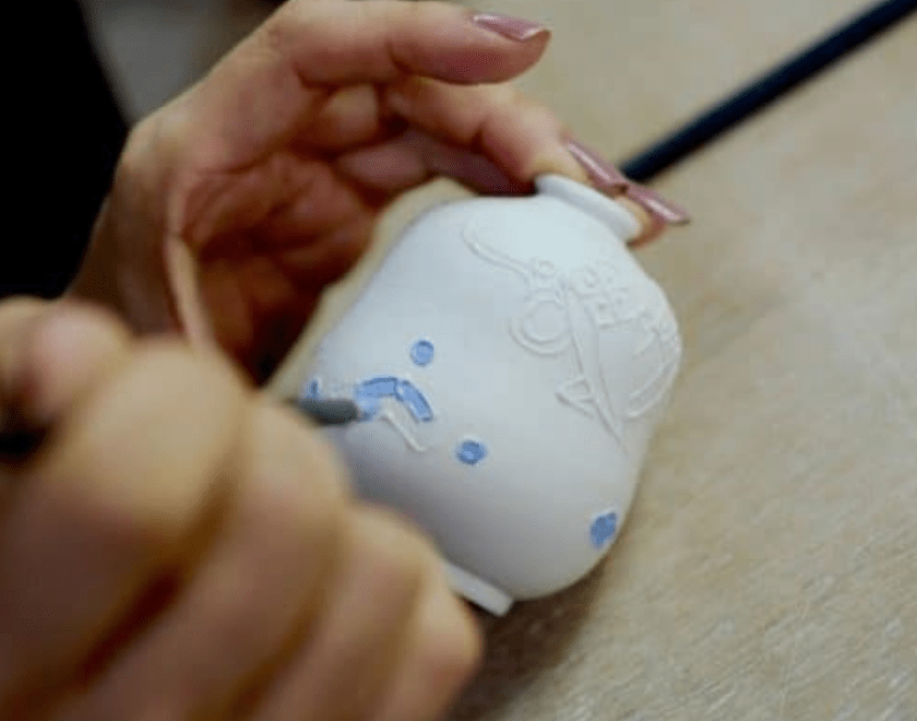 Hand painting a pot