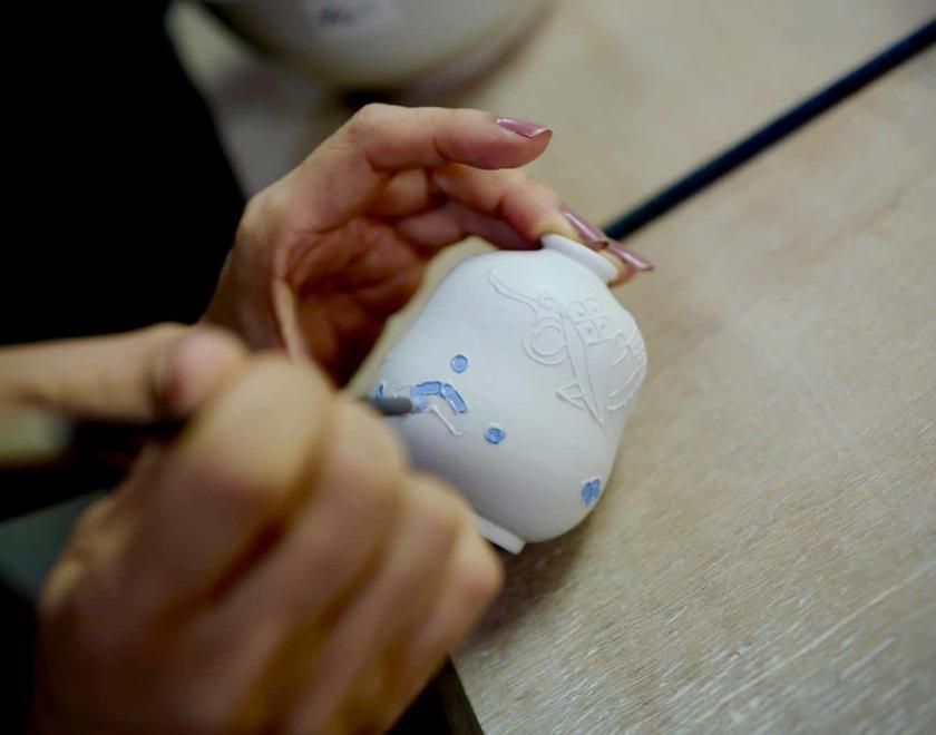 Hand painting a pot