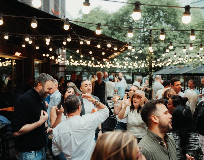 happy crowd in the outside space at Vino.Vita