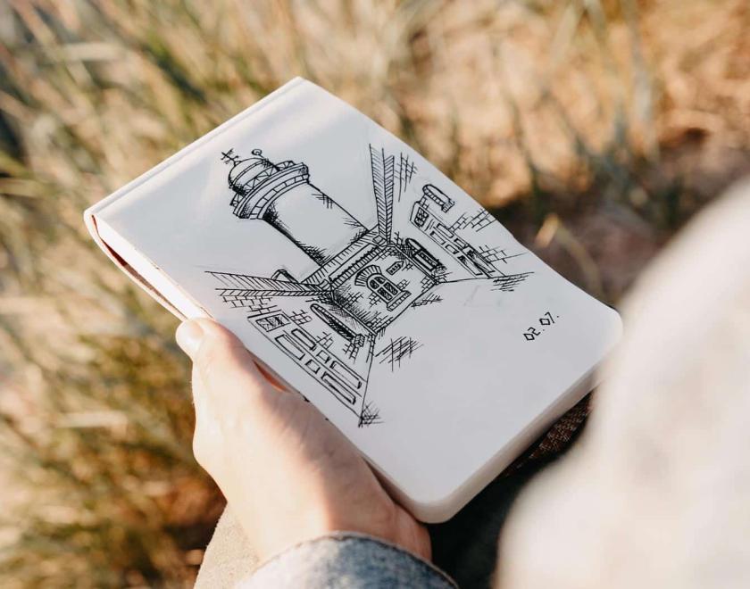 Hand drawing on a page in a field