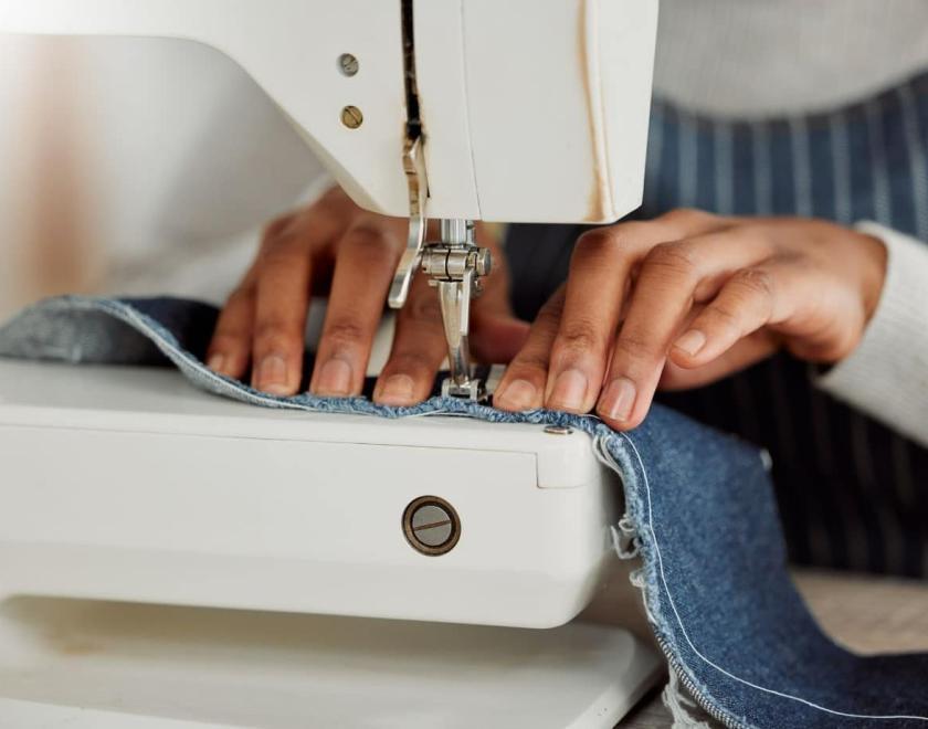 Person sewing with a sewing machine