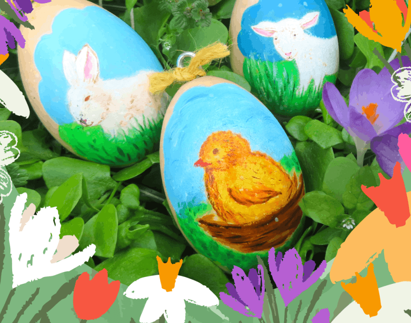 Painted Easter eggs lying in grass and flowers
