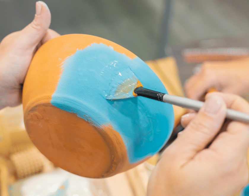 Hand painting a pot