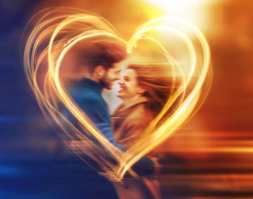 A man and a woman in a heart made of light. The image is intentioanlly blurred.