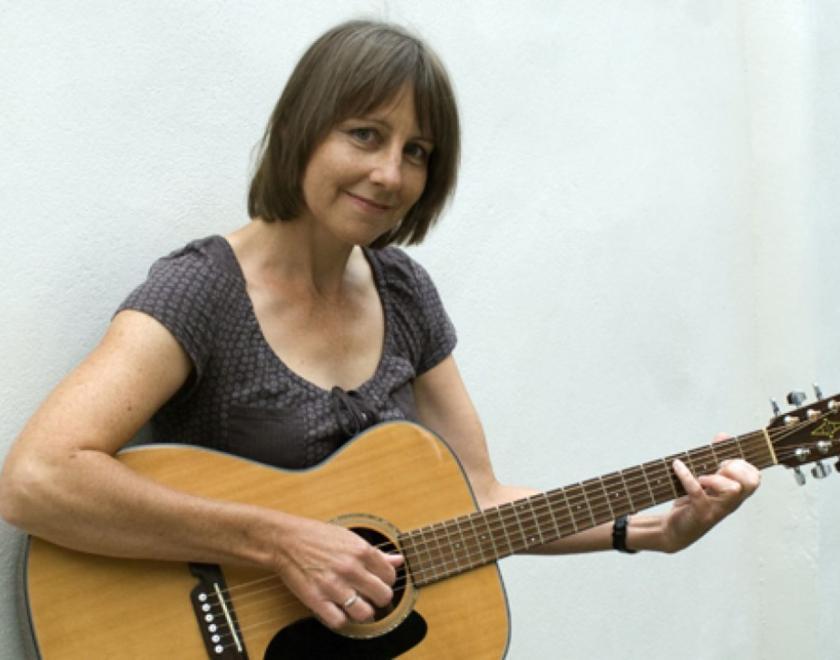 Photo of Liz Simcock with a guitar