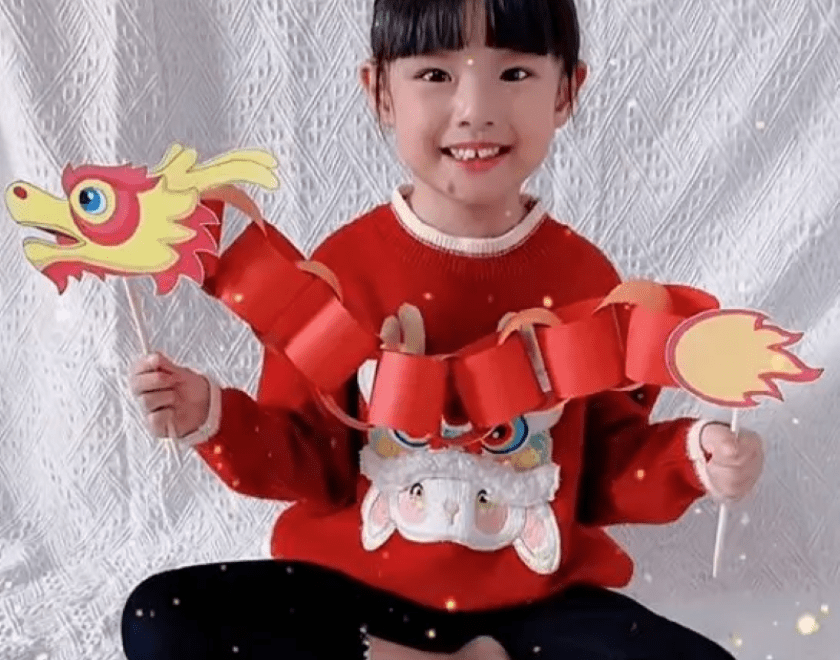 Girl holding a paper chain Chinese dragon