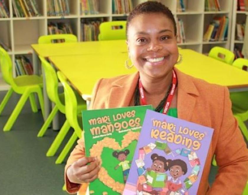 Author Marva Carty holding her books