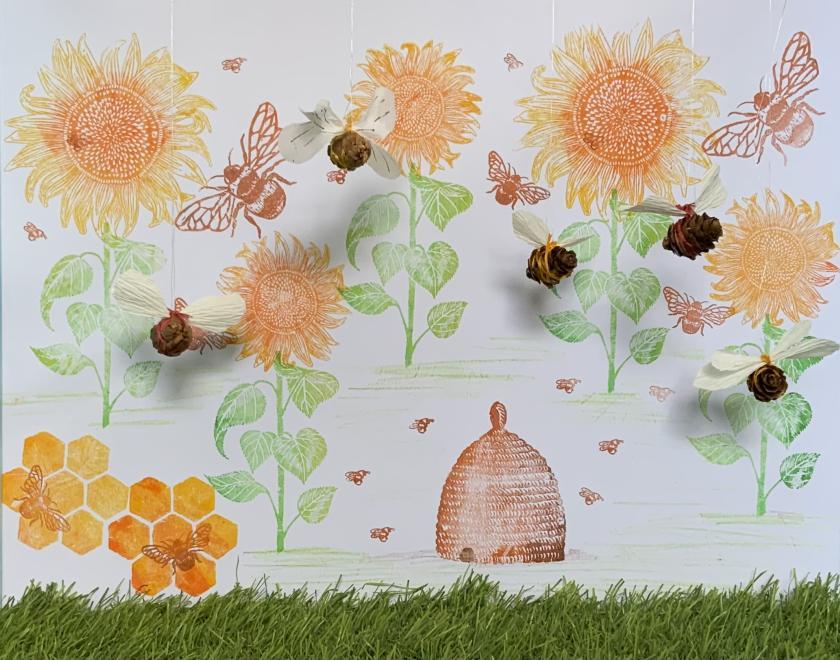picture of handmade bees with painted flowers in the background