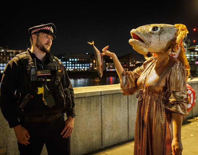 costumed performer with police officer